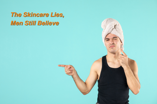 Young man with a towel wrapped around his head pointing to his face, highlighting the blog theme ‘The Skincare Lies Men Still Believe’ on a teal background