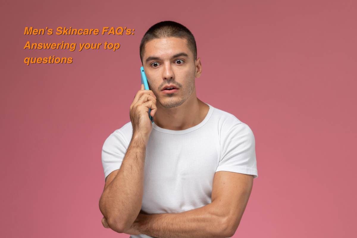 Young man in a white t-shirt talking on a smartphone with a surprised expression, with text overlay reading “Men’s Skincare FAQ’s: Answering your top questions.
